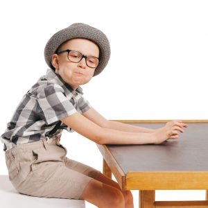 portrait-little-stylish-boy-choild-sitting-posing-isolated-white-studio-background_155003-46693